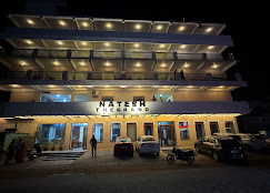 Hotel Natesh The Grand night exterior with Natesh signage